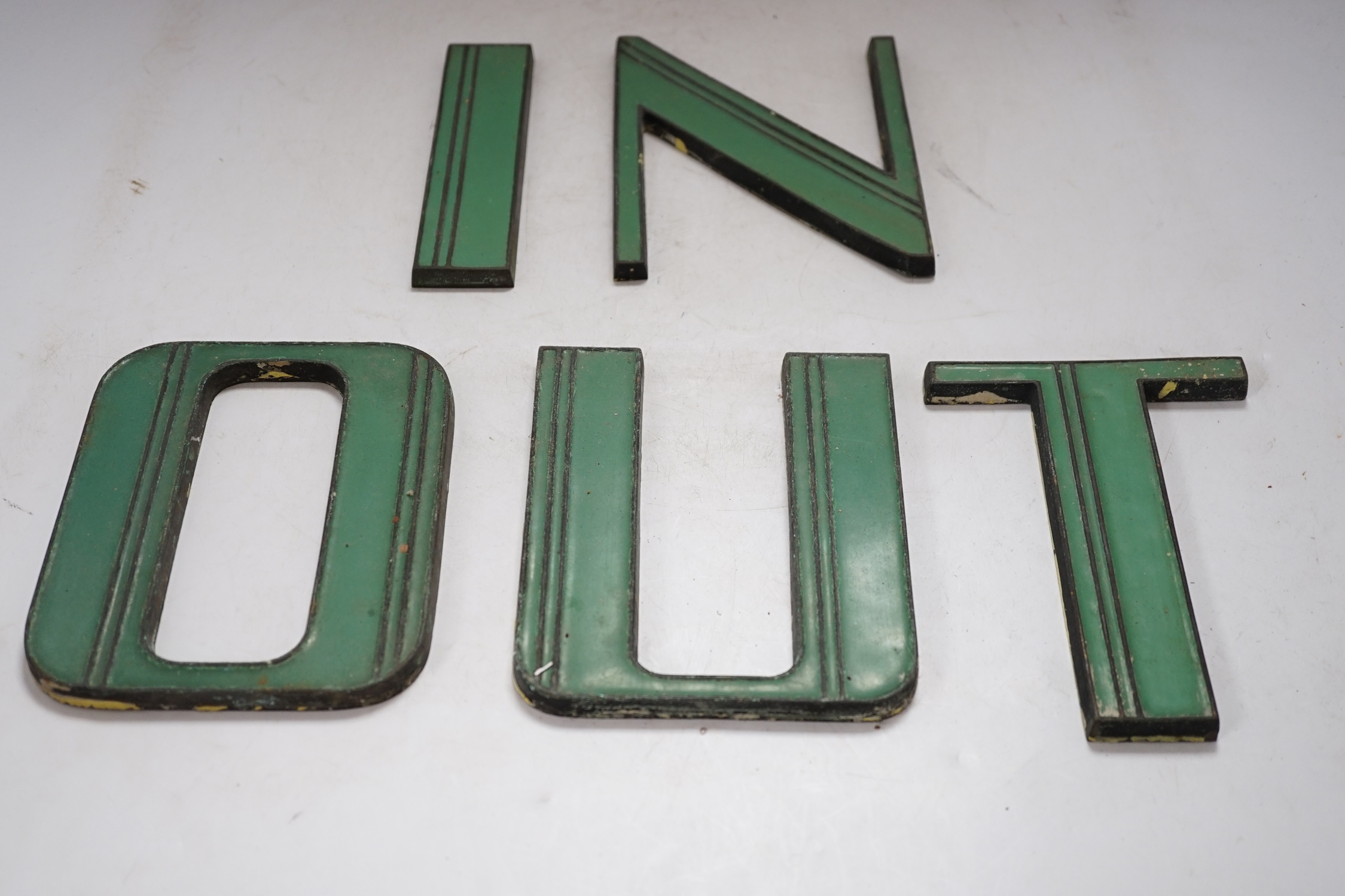 Art Deco green enamelled cast metal letters to spell ‘IN’ and ‘OUT’, 15cm tall. Condition - fair to good